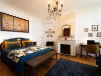 Lit 160x200 en linge de lin, cheminée en pierre et décoration rétro dans la Chambre Domeyne du Château Papounan, chambre d’hôtes de charme à Saint-Estèphe, Médoc.